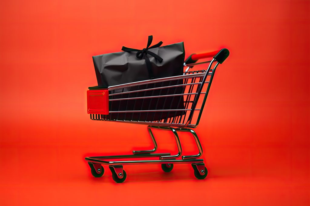 Black Paper Bags In Shopping Cart On Red Background
