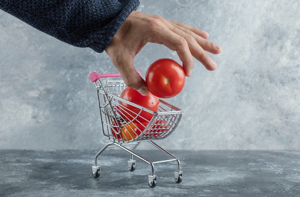 Male Hand Taking Tomato From Shopping Cart